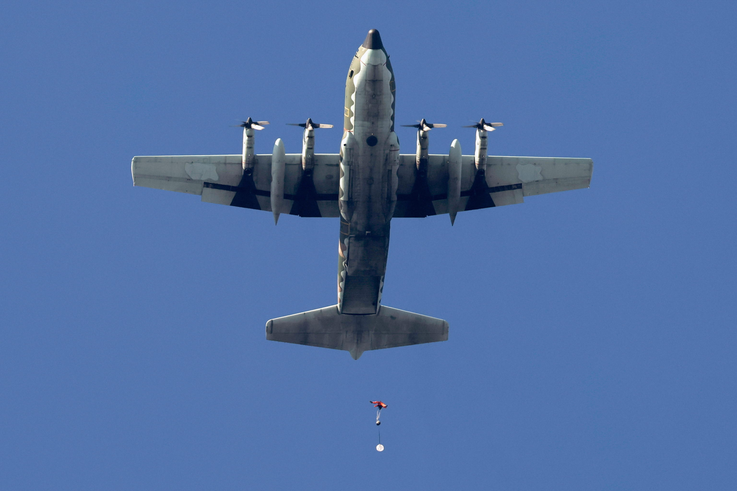 epa11786581 A Taiwanese paratrooper jumps from a C-130 plane during a live training session in Pingtung city, Taiwan, 20 December 2024. According to a 18 December report published by the United States Department of Defense (DoD), China continued to increase diplomatic, political, and military pressure against Taiwan in 2023.  EPA/RITCHIE B. TONGO