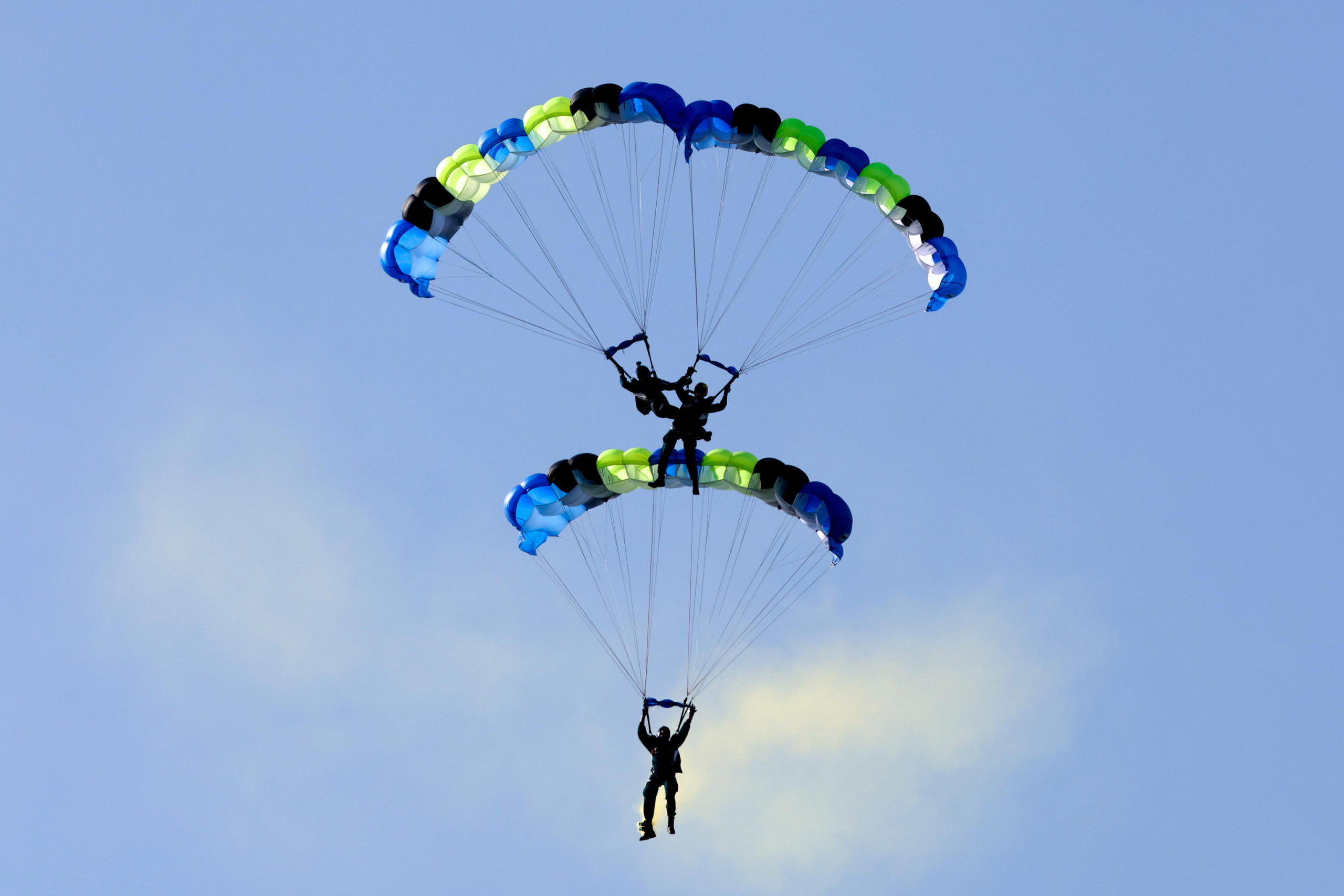 epa11786575 Taiwanese paratroopers perform a formation after jumping from a C-130 plane during a live training session in Pingtung city, Taiwan, 20 December 2024. According to a 18 December report published by the United States Department of Defense (DoD), in 2023, China continued to increase diplomatic, political, and military pressure against Taiwan.  EPA/RITCHIE B. TONGO