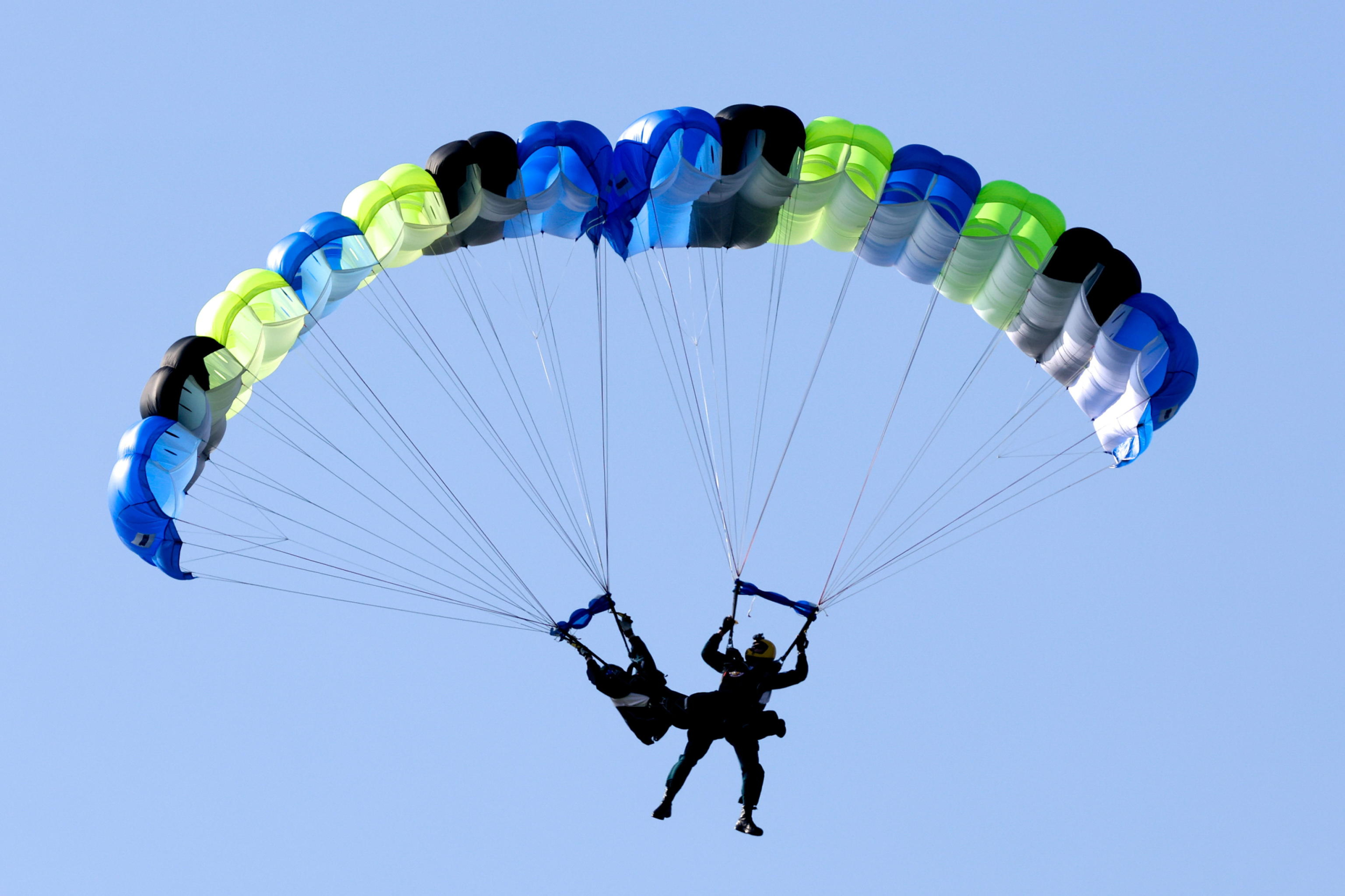 epa11786576 Taiwanese paratroopers perform a formation after jumping from a C-130 plane during a live training session in Pingtung city, Taiwan, 20 December 2024. According to a 18 December report published by the United States Department of Defense (DoD), in 2023, China continued to increase diplomatic, political, and military pressure against Taiwan.  EPA/RITCHIE B. TONGO