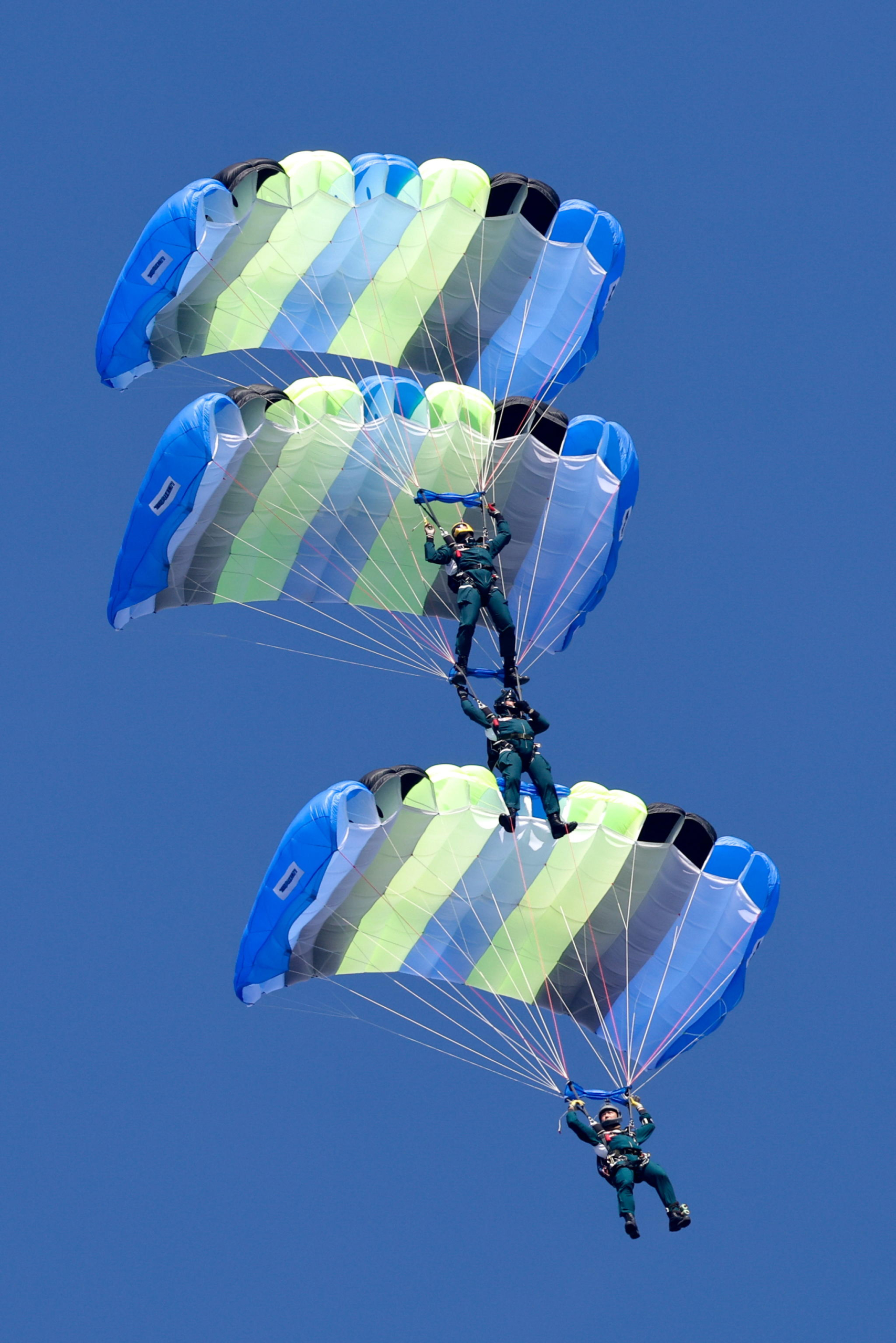 epa11786579 Taiwanese paratroopers perform a formation during a live training session in Pingtung city, Taiwan, 20 December 2024. According to a 18 December report published by the United States Department of Defense (DoD), in 2023, China continued to increase diplomatic, political, and military pressure against Taiwan.  EPA/RITCHIE B. TONGO