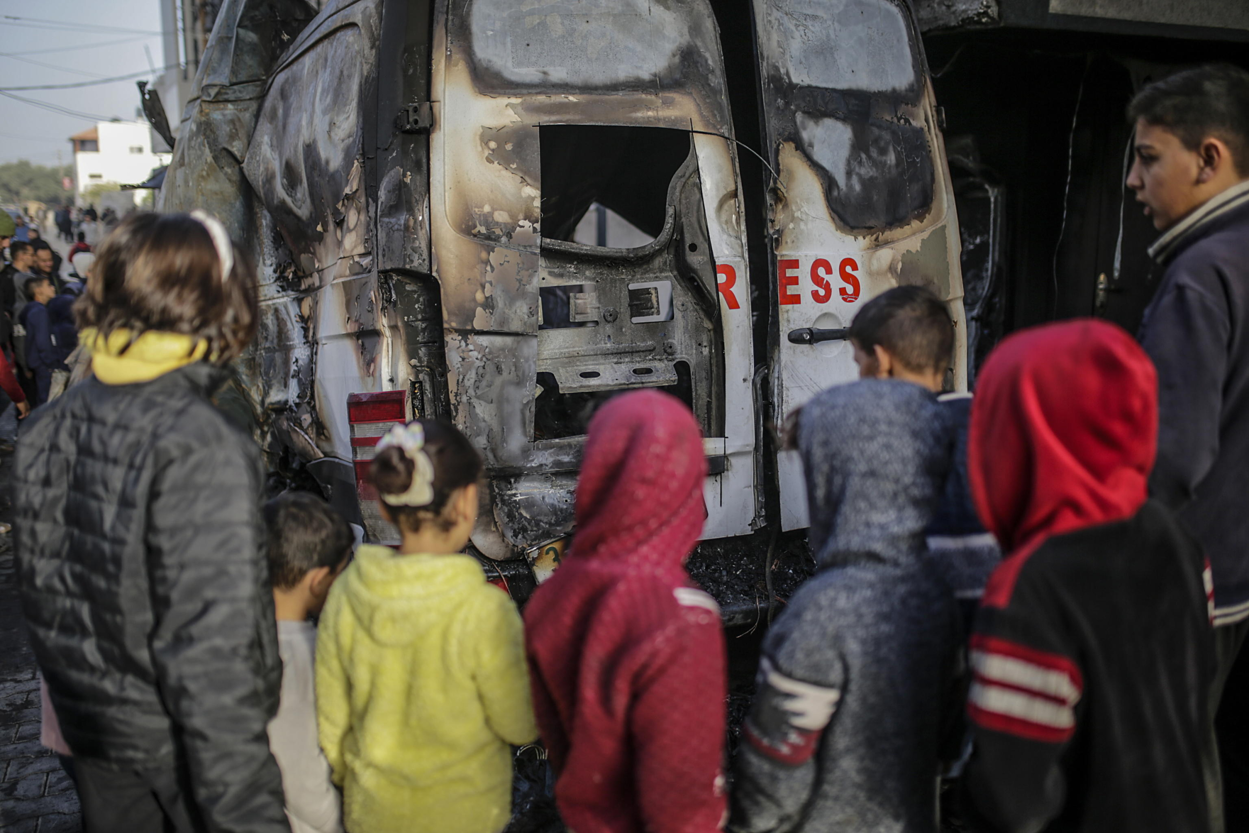 epaselect epa11793705 Palestinians inspect a destroyed vehicle near Al Awda hospital following an Israeli airstrike in Al Nuseirat refugee camp, central Gaza Strip, 26 December 2024. According to the Government Media Office (GMO) in Gaza, five journalists from the 'Al-Quds Today' TV satellite channel were killed after an overnight Israeli airstrike hit their vehicle in Al Nuseirat camp, central Gaza. More than 45,000 Palestinians and over 1,400 Israelis have been killed, according to the Palestinian Health Ministry and the Israeli Army, since Hamas militants launched an attack against Israel from the Gaza Strip on 07 October 2023, and the Israeli operations in Gaza and the West Bank which followed it.  EPA/MOHAMMED SABER