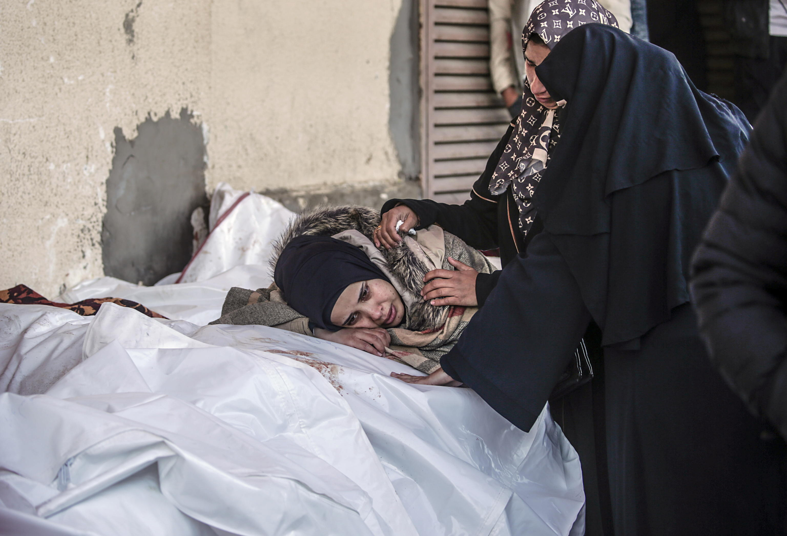 epa11803182 A Palestinian woman mourns during the funeral of her relatives killed in Israeli air strikes, in Al Aqsa Martyrs Hospital, in Deir Al Balah, central Gaza Strip, 03 January 2025. According to reports from the Ministry of Health in Gaza, more than 29 people were killed following Israeli air strikes in the refugee camps of central Gaza Strip. More than 45,500 Palestinians and over 1,400 Israelis have been killed, according to the Palestinian Health Ministry and the Israeli Army, since Hamas militants launched an attack against Israel from the Gaza Strip on 07 October 2023 and the Israeli operations in Gaza and the West Bank that followed it.  EPA/MOHAMMED SABER