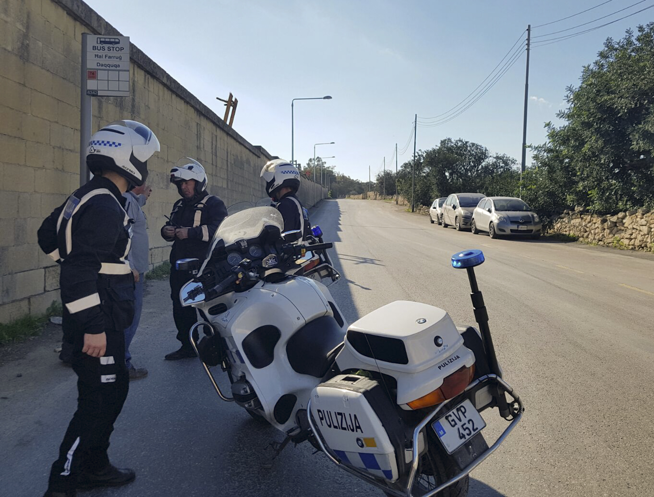 Maltese police officers close off a road by Malta's Luqa International airport after an Afriqiyah Airways plane from Libya landed at the airport in an apparent hijack, Friday, Dec. 23, 2016. Malta's state television says two hijackers who diverted a Libyan commercial plane to the Mediterranean island nation have threatened to blow it up. (AP Photo/Jonathan Borg)