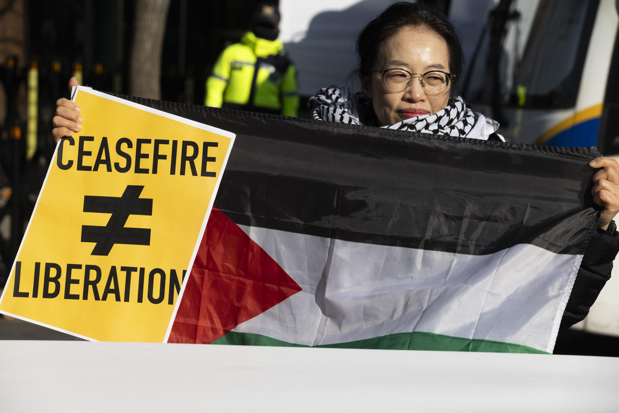 epaselect epa11829743 A member of Action4Palestine Korea hold up a Palestinian flag and placard calling for the liberation of Palestinians during a rally outside the Israeli embassy in Seoul, South Korea, 17 January 2025. Protesters gathered to demand that Israel approve a Gaza ceasefire and hostage deal after Israeli Prime Minister Benjamin Netanyahu delayed a cabinet vote on the agreement on 16 January.  EPA/JEON HEON-KYUN