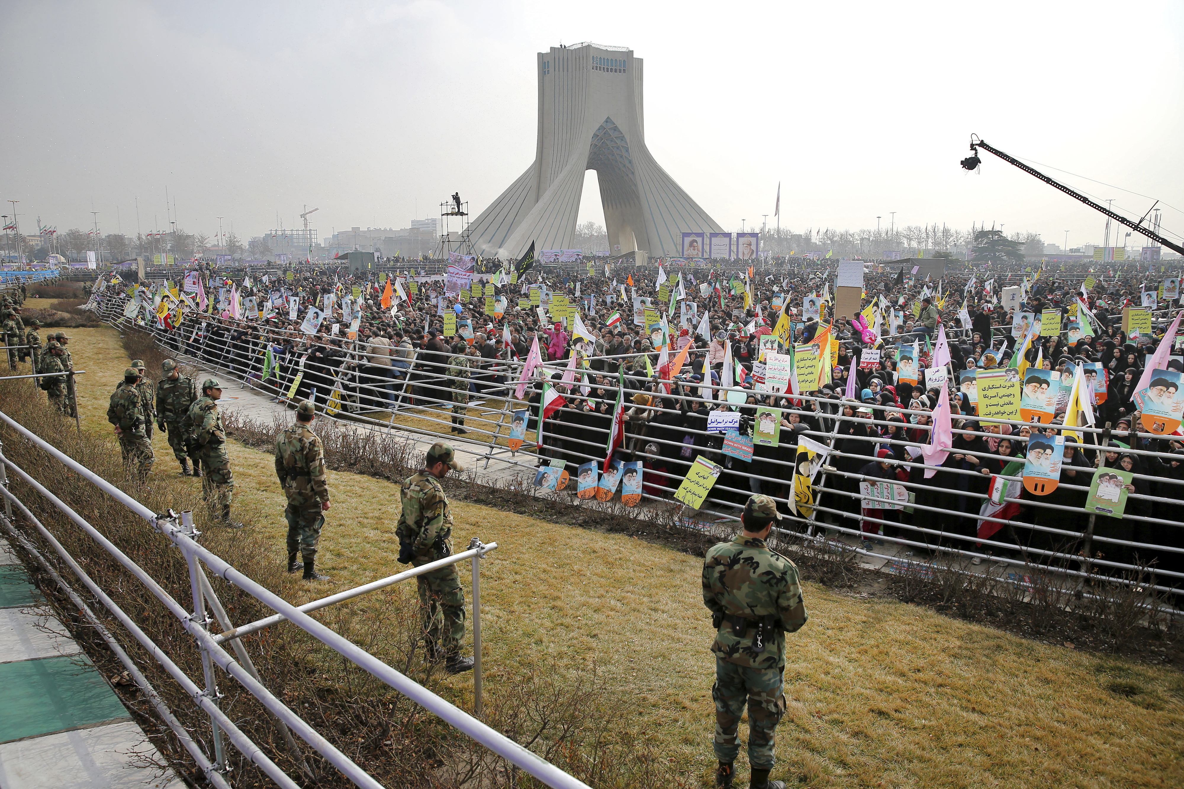 Security forces stand guard at an annual rally commemorating the anniversary of the 1979 Islamic revolution, which toppled the late pro-U.S. Shah, Mohammad Reza Pahlavi, under the Azadi, 'Freedom' monument tower in Tehran, Iran, Friday, Feb. 10, 2017. (AP Photo/Ebrahim Noroozi)