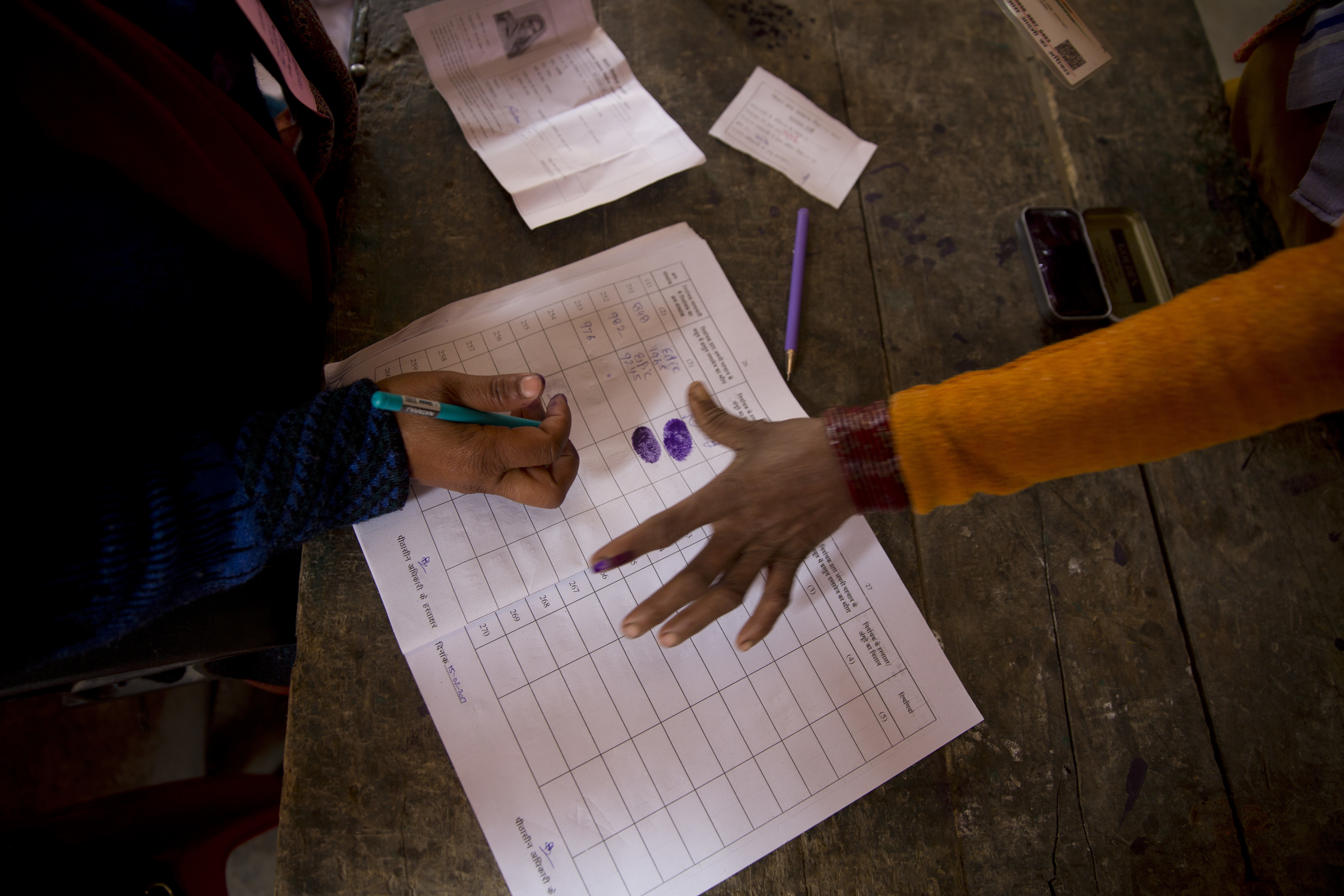 A woman gives a thumb impression before she casts her vote at a polling station near Amroha in Uttar Pradesh, India, Wednesday, Feb. 15, 2017. Uttar Pradesh and four other Indian states are having state legislature elections in February-March, a key mid-term test for Prime Minister Narendra Modi's Hindu nationalist government which has been ruling India since 2014. (AP Photo/Manish Swarup)