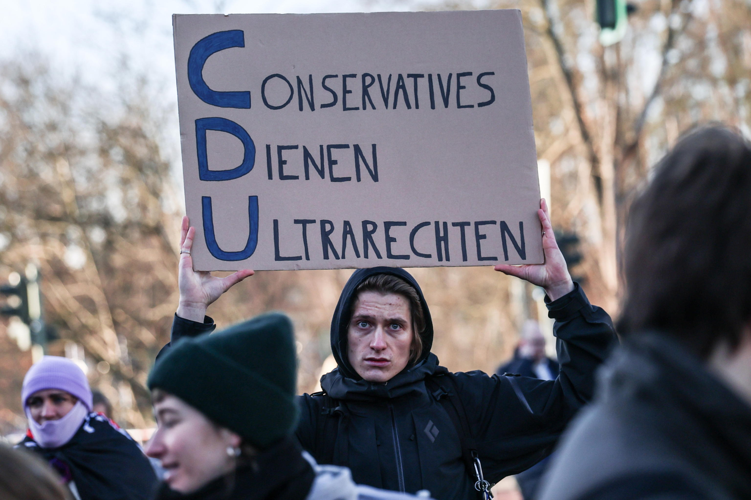 epa11872280 A protester holds a sign reading 'Conservatives serve Ultra Right' during a protest against cooperation with the Alternative for Germany 'AfD' party ahead of the Christian Democratic Union 'CDU' federal party conference in Berlin, Germany, 03 February 2025. People gathered to protest against the CDU's cooperation with the AfD party after the CDU's motion in the Bundestag won a majority with the help of AfD votes.  EPA/Filip Singer