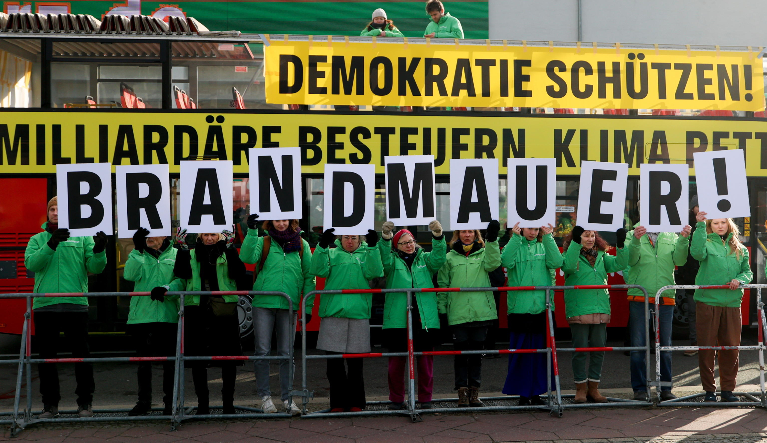 epa11872429 People hold a sign read 'Firewall' during a protest against cooperation with the Alternative for Germany 'AfD' party ahead of the Christian Democratic Union 'CDU' federal party conference in Berlin, Germany, 03 February 2025. People gathered to protest against the CDU's cooperation with the AfD party after the CDU's motion in the Bundestag won a majority with the help of AfD votes.  EPA/Filip Singer