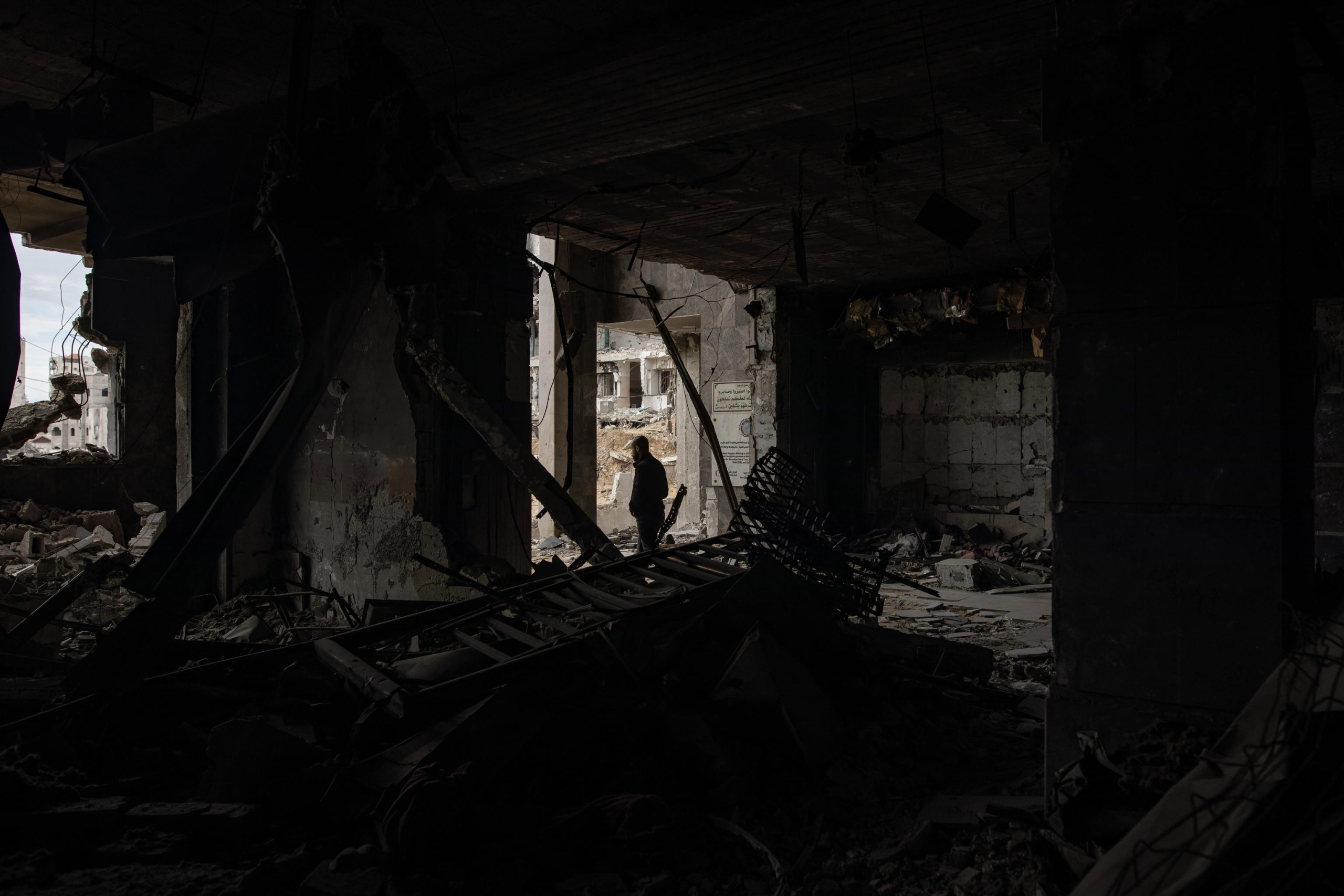 epa11876226 A man walks through the damage Al-Shifa hospital, amid a ceasefire between Israel and Hamas, in Gaza City, Gaza Strip, 05 February 2025. Israel and Hamas implemented the first phase of a hostage release and ceasefire deal on 19 January 2025. More than 46,000 Palestinians have been killed in the Gaza Strip, according to the Palestinian Ministry of Health, since Israel launched a military campaign in the strip in response to a cross-border attack led by the Palestinian militant group Hamas on 07 October 2023, in which about 1,200 Israelis were killed and more than 250 taken hostage.  EPA/HAITHAM IMAD