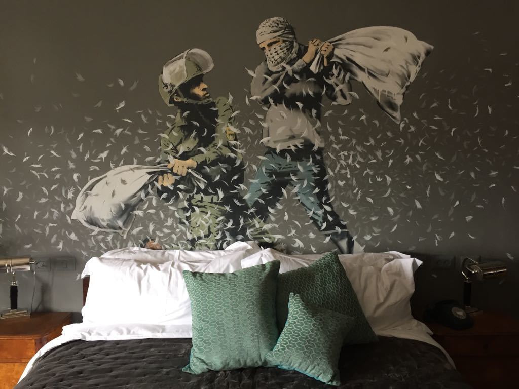 A bedroom in a new guesthouse shows artwork by Banksy in the West Bank city of Bethlehem on Friday. Mar. 3, 2017. The owner says he is putting the finishing touches to the 
