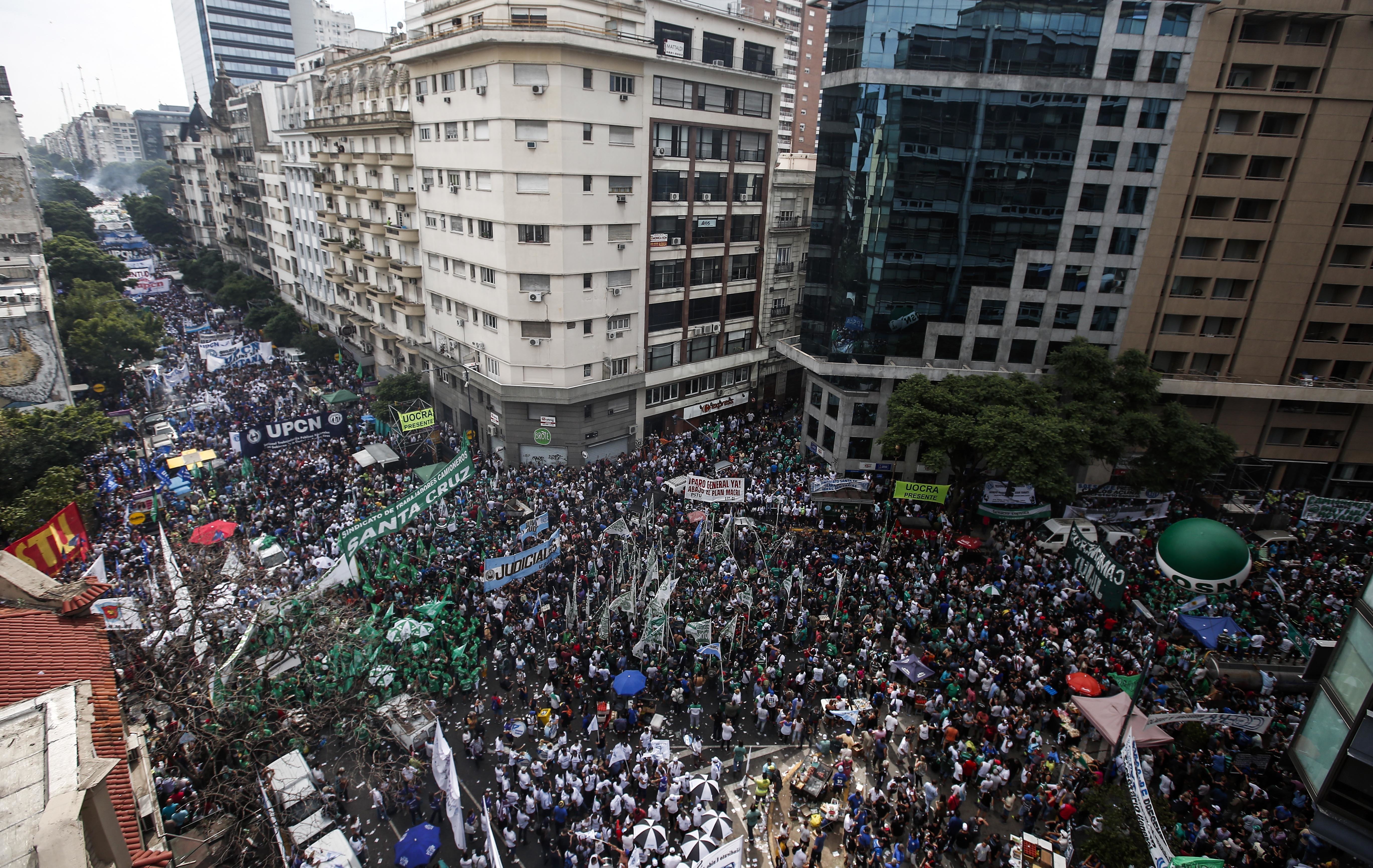 Thousands of demonstrators march in Buenos Aires, Argentina, Tuesday, March 7, 2017. Argentina's most powerful unions brought tens of thousands of people into the capital's streets to protest government job cuts, the lifting of restrictions on imports and other policies of President Mauricio Macri. (AP Photo/Agustin Marcarian)