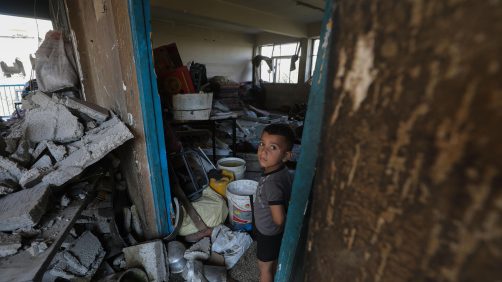 epa11478206 A Palestinian boy looks on while standing among debris inside a damaged UNRWA school following an Israeli air strike in Al Nuseirat refugee camp, central Gaza Strip, 14 July 2024. At least 12 people were killed following an Israeli air strike in the camp, according to the Palestinian Ministry of Health. The Israeli military stated on 14 July, that the Israeli Air Force (IAF) struck the area of UNRWA's Abu Oraiban School School building in Nuseirat, claiming that the location served as a 'hideout and operational infrastructure' to direct and carry attacks against Israeli troops operating in the Gaza Strip. More than 38,000 Palestinians and over 1,400 Israelis have been killed, according to the Palestinian Health Ministry and the Israel Defense Forces (IDF), since Hamas militants launched an attack against Israel from the Gaza Strip on 07 October 2023, and the Israeli operations in Gaza and the West Bank which followed it.  EPA/MOHAMMED SABER