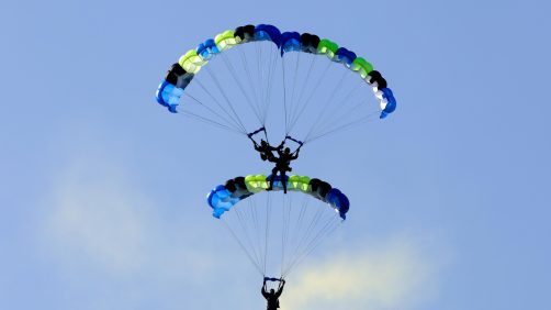 epa11786575 Taiwanese paratroopers perform a formation after jumping from a C-130 plane during a live training session in Pingtung city, Taiwan, 20 December 2024. According to a 18 December report published by the United States Department of Defense (DoD), in 2023, China continued to increase diplomatic, political, and military pressure against Taiwan.  EPA/RITCHIE B. TONGO