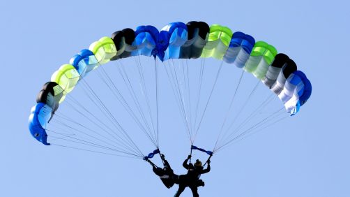 epa11786576 Taiwanese paratroopers perform a formation after jumping from a C-130 plane during a live training session in Pingtung city, Taiwan, 20 December 2024. According to a 18 December report published by the United States Department of Defense (DoD), in 2023, China continued to increase diplomatic, political, and military pressure against Taiwan.  EPA/RITCHIE B. TONGO