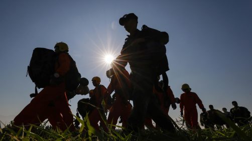 epa11786587 Taiwanese paratroopers carry their parachutes after jumping from a C-130 plane during a live training session in Pingtung city, Taiwan, 20 December 2024. According to a 18 December report published by the United States Department of Defense (DoD), China continued to increase diplomatic, political, and military pressure against Taiwan in 2023.  EPA/RITCHIE B. TONGO