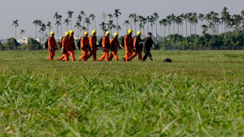 epa11786585 Taiwanese paratroopers carry their parachutes after jumping from a C-130 plane during a live training session in Pingtung city, Taiwan, 20 December 2024. According to a 18 December report published by the United States Department of Defense (DoD), China continued to increase diplomatic, political, and military pressure against Taiwan in 2023.  EPA/RITCHIE B. TONGO